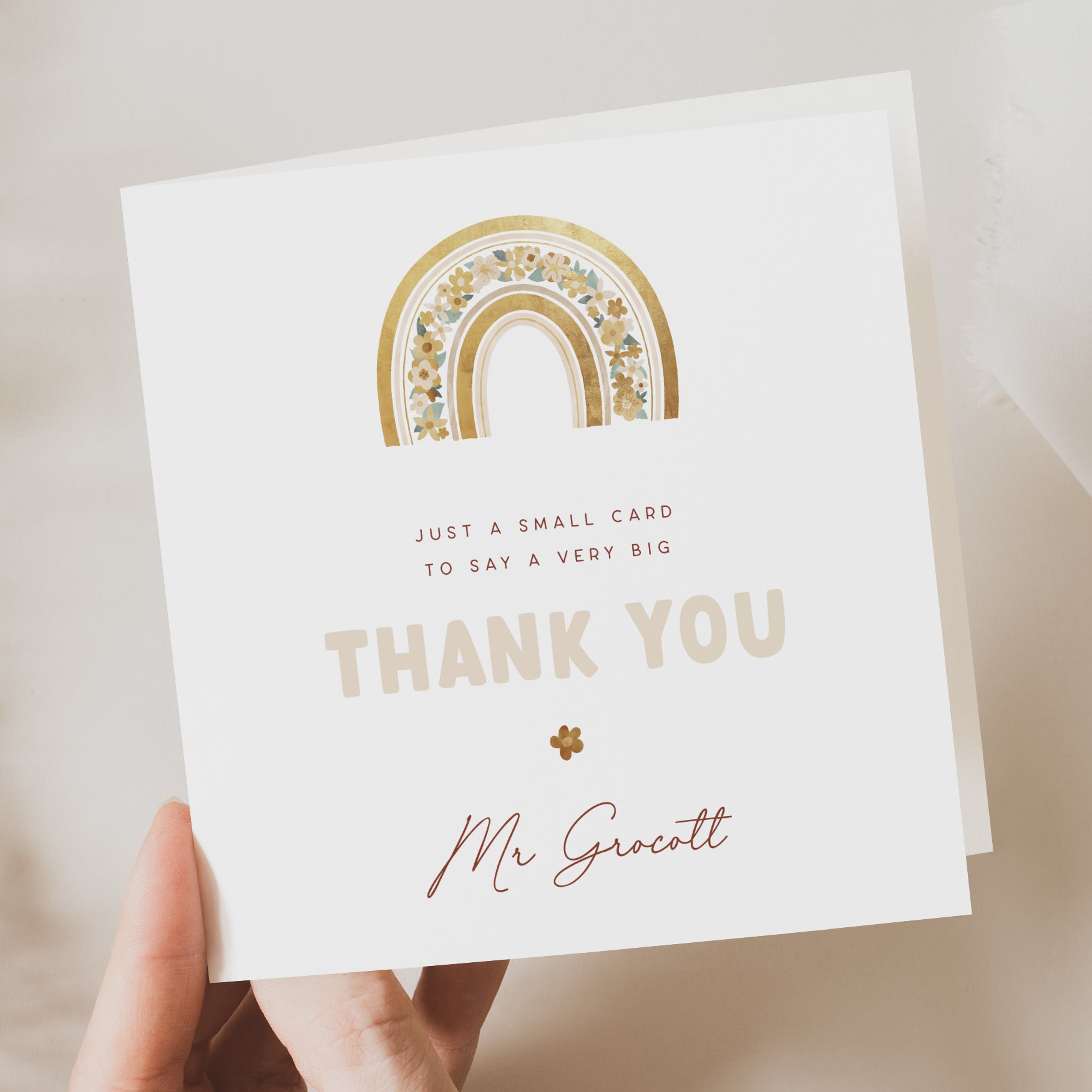 Personalised thank you teacher card featuring a golden rainbow with floral accents, the text “THANK YOU,” and the custom name “Mr Grocott.” Message reads “Just a small card to say a very big thank you.”