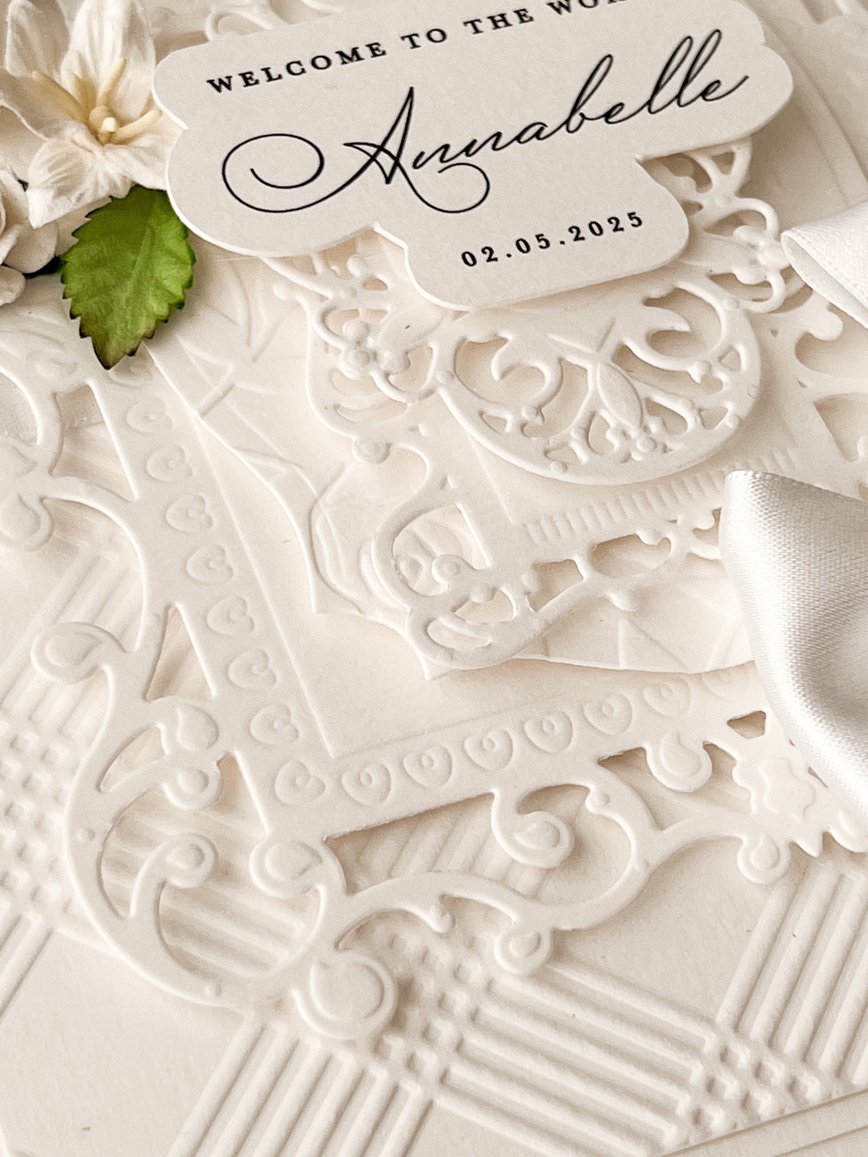 close up of embossing and debossing on luxury new baby card